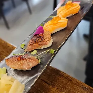 2 pc seared A5 Wagyu nigiri and 2 pc salmon belly nigiri