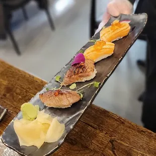 2 pc seared A5 Wagyu nigiri and 2 pc salmon belly nigiri