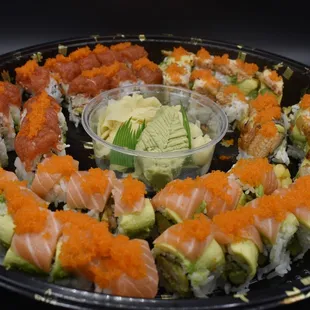 a platter of sushi and avocado