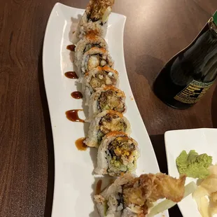 a plate of sushi and a bottle of beer