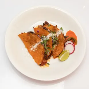 Quesabirria! Stuffed with cheese, shredded birria, onions, cilantro, and queso cotija.