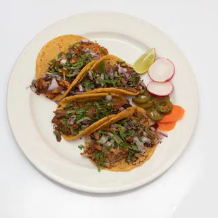 Street Tacos served on a soft corn tortilla and topped with onions &amp; cilantro