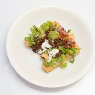Flautas stuffed with potatoes and topped with your choice of meat!