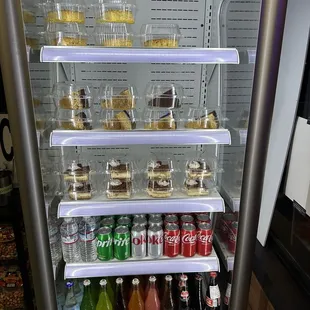 a display of various drinks and desserts