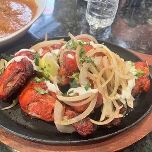 a plate of meat and onions