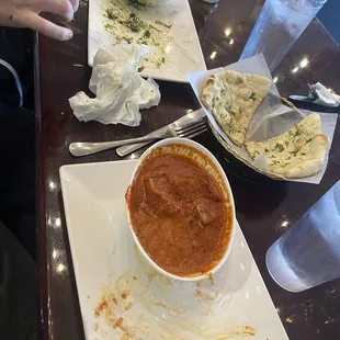 On the left chicken Saag, the middle Garlic Naan, and on the right is chicken masala