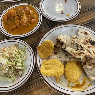 Butter chicken, vegetable fried rice, potato fritters, naan