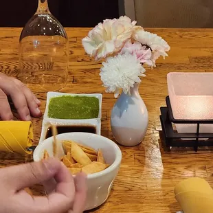 a person dipping sauce into a bowl
