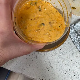 a person holding a bowl of masala