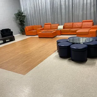 a modern living room with orange leather furniture