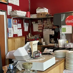 a restaurant counter with plates and bowls on it