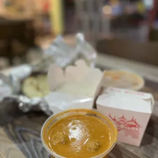 a bowl of masala and a box of donuts