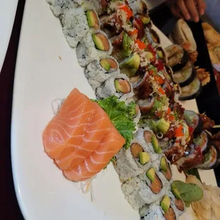 Salmon sashimi, salmon avo rolls, dancing eel roll, showering roll, shrimp tempura roll, and spider roll