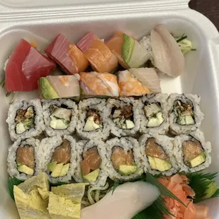 a variety of sushi in a styrofoam container