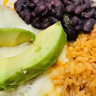 Sour Cream and Avocado Chicken Enchiladas with Black Beans and Rice.