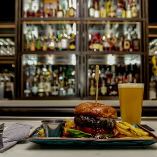 a plate of food and a glass of beer