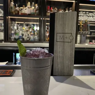 a cocktail in a metal cup