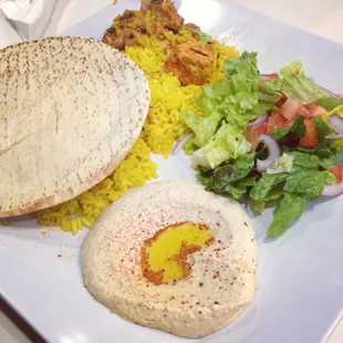 Chicken Kebob Plate with rice, pita bread, hummus, and garden salad