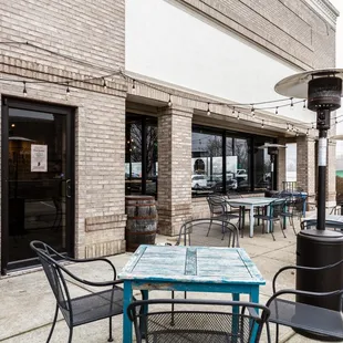 a patio with tables and chairs
