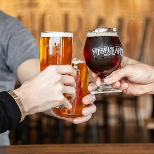 two men toasting with beer glasses