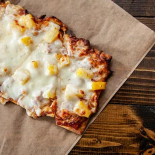 a piece of pizza on a piece of paper