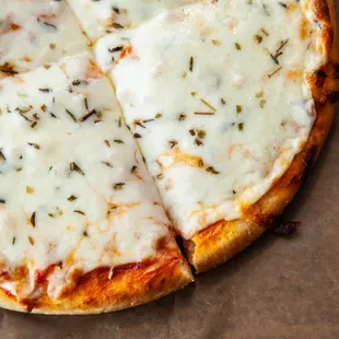 a pizza with cheese and herbs