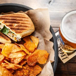 a panini sandwich and potato chips