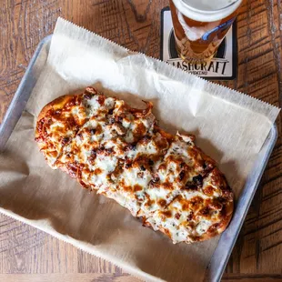 a slice of pizza and a beer