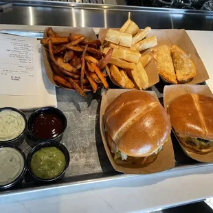 Puerto Rican burger, classic burger, yuca fries, sweet potato fries, and two empanadas (one beef and one cheese). All good!