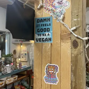 stickers on a wooden pole