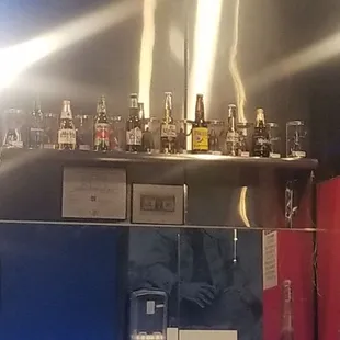 a shelf of alcohol bottles