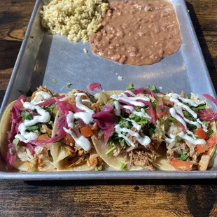 Street tacos with rice and refried beans