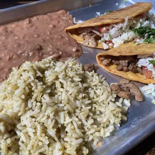 Hard shell tacos with rice and refried beans