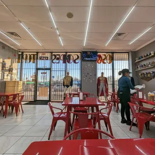 a restaurant with red tables and red chairs