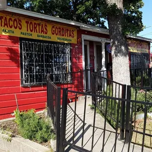 a red building with a sign on it