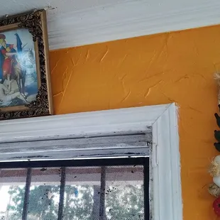 a picture of jesus on the wall above a window