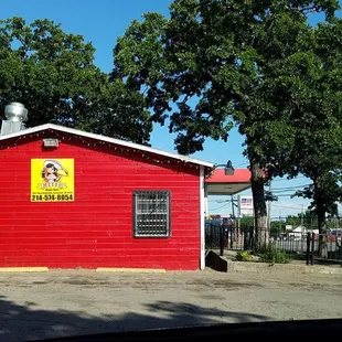 a red building with a sign on it