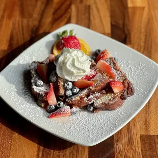 French Toast with cinnamon swirl bread, fresh mixed berries, and a dusting of powder sugar.