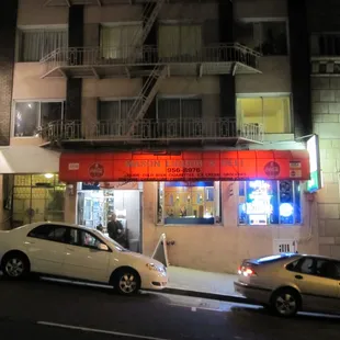 two cars parked in front of a building