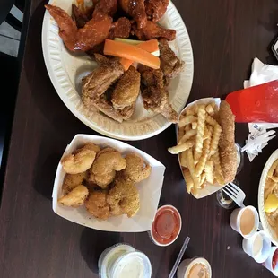 two plates of chicken and fries