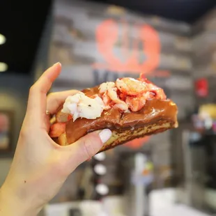 a hand holding a pastry