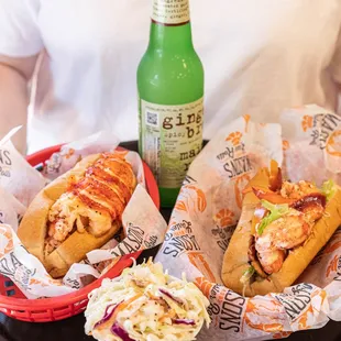 a woman holding a tray of sandwiches