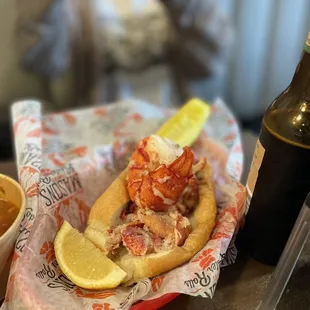 a lobster roll with a slice of lemon on top