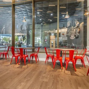 a dining area with red chairs