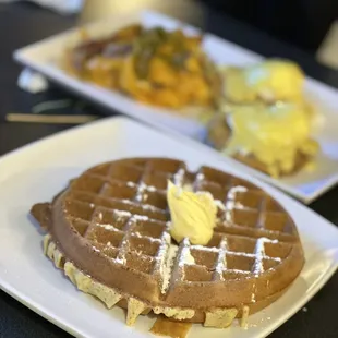 a plate of waffles with butter