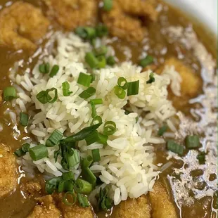 a bowl of soup with meatballs and gravy