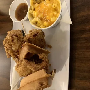 Chicken and waffles with syrup and Mac and cheese side