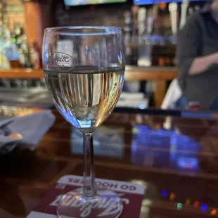 a glass of wine on a bar
