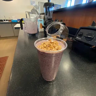 a smoothie in a plastic cup on a counter