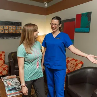 A client being greeted before an appointment by one of our student massage therapists